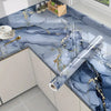 Blue marble self-adhesive PVC wallpaper featuring gold veining used as a kitchen backsplash.