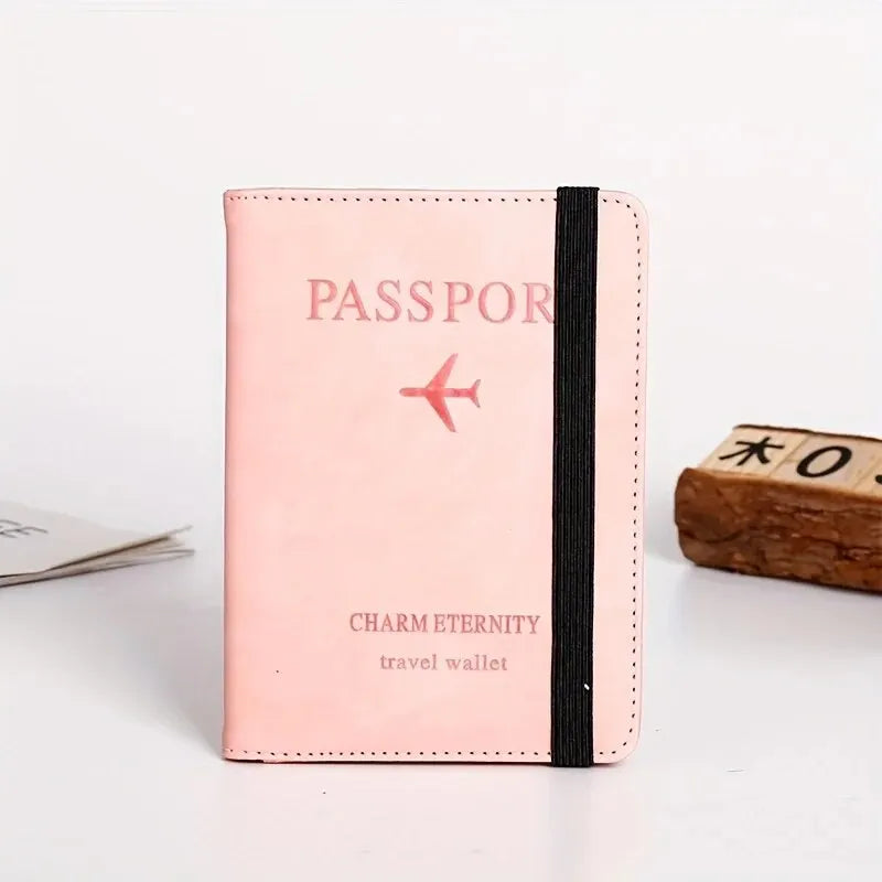 A pink leather passport cover and travel wallet with a black strap and a red airplane emblem.