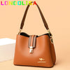 A brown leather shoulder bag with a gold-toned strap and flap closure resting on a light background.