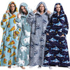Four women modeling a blue and gray oversized wearable blanket hoodie with a hood