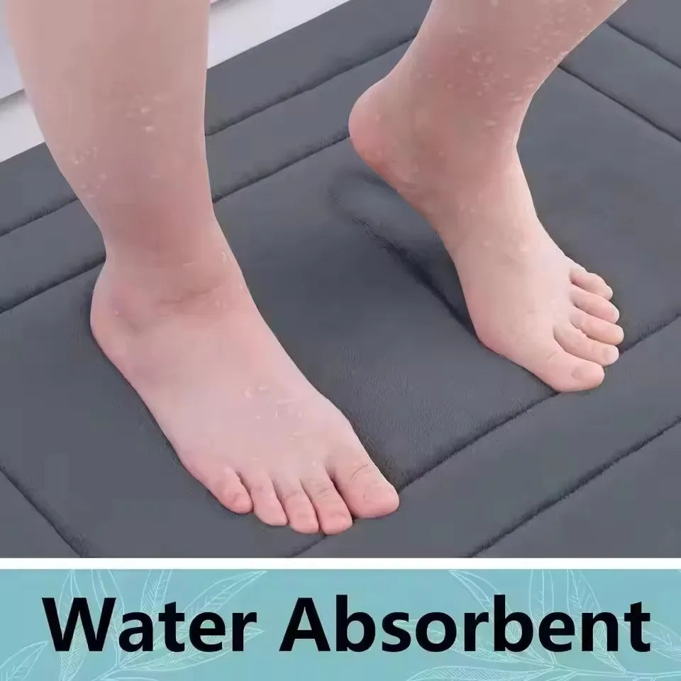 Close-up of a foot resting on a dark gray absorbent mat, demonstrating the non-slip texture.