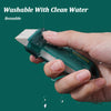 A hand is using a green reusable limescale and stain eraser on a faucet or tile.