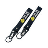 Black leather strap with yellow text Save The Manuals and a clasp keychain.