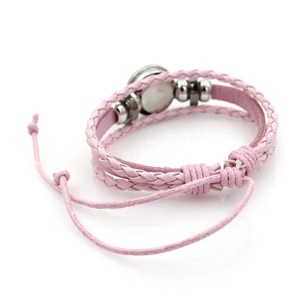 A pink leather bracelet set featuring a silver moon charm and a matching pink cord.