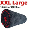 A rolled black microfiber car drying towel with red accents.
