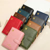 A stack of leather RFID-blocking passport wallets in various colors, including red, green, brown, and navy blue.