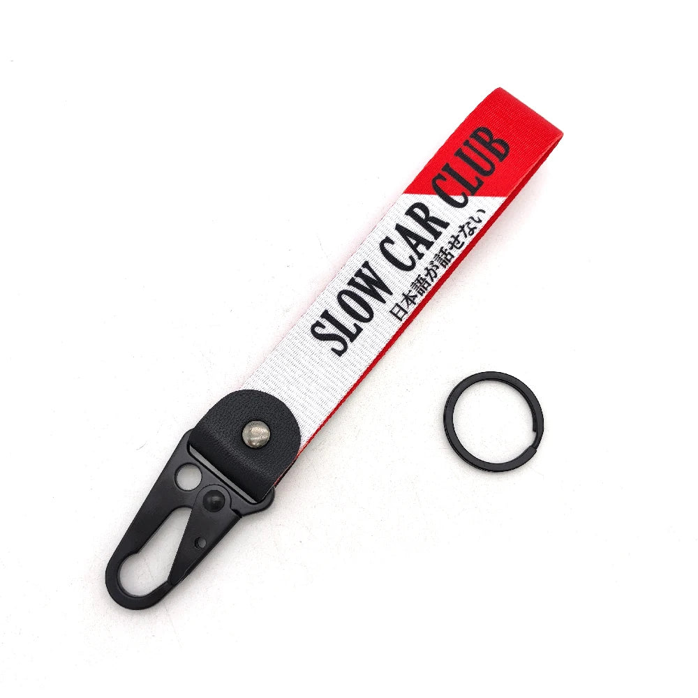 Red and white striped nylon keychain with a steel clip and Japanese text