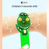 A green dinosaur-themed slap watch bracelet is shown being worn on a finger against a light background.