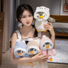 A woman holds a fluffy white penguin plush toy with an adorable hat and another small pink penguin plush toy.