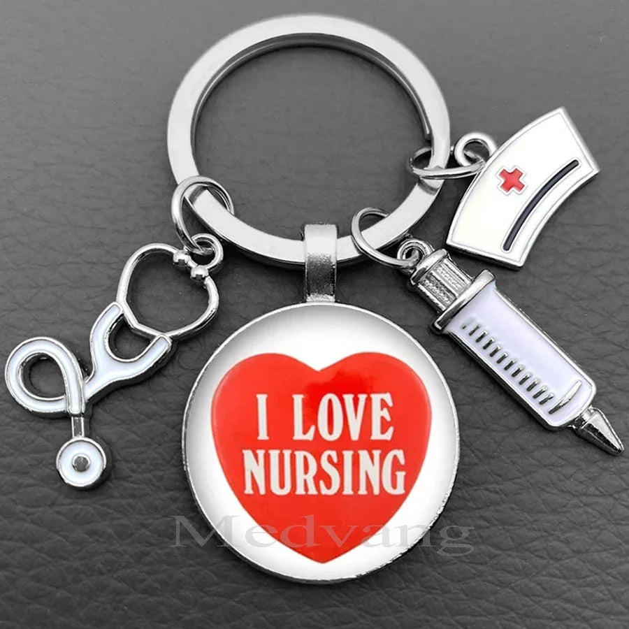 Silver nurse keychain featuring a heart pendant with the text I LOVE NURSING and a medical syringe charm