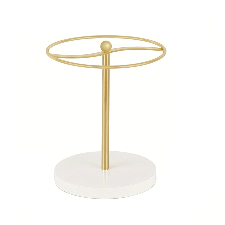 A gold-colored sunglasses organizer stand with a circular hoop and a wooden base.