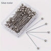 A clear plastic container filled with 100 silver-colored precision quilting pins for sewing and crafting.