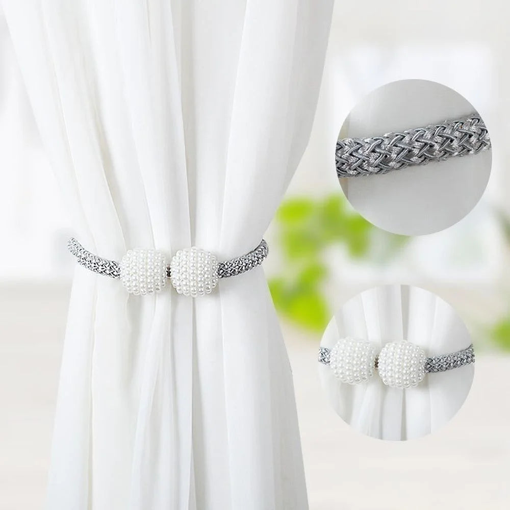 Silver braided pearl magnetic curtain tie-back clips shown on a white fabric backdrop.