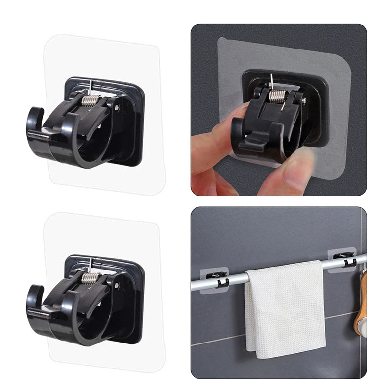 Two black self-adhesive no-drill curtain rod brackets are shown in close-up against a gray background.