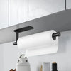 A white paper towel roll is mounted on a black wall-mounted holder above a kitchen counter.