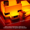 A glowing orange fox night light shaped like a blocky character resting on a wooden surface.