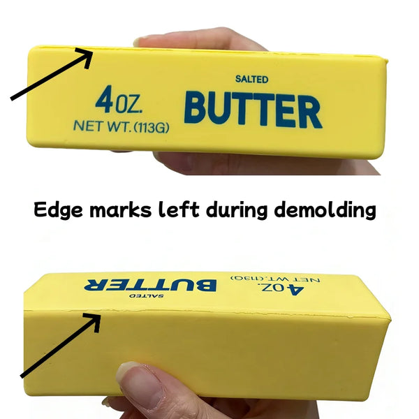 A yellow butter stick squishy toy box with salted butter labeling and edge marks left from demolding.