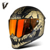 A black full-face motorcycle helmet featuring a gold and black graphic design and an orange visor.