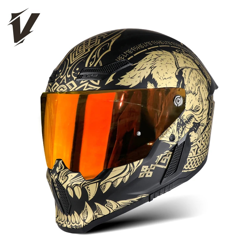 A black full-face motorcycle helmet featuring a gold and black graphic design and an orange visor.
