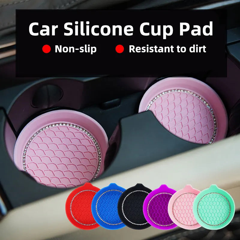 A collection of pink and colored silicone cup pad coasters with rhinestone accents shown in a car cup holder.