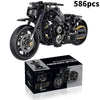 A detailed black motorcycle model kit with 586 pieces of parts and tools displayed next to its packaging box.