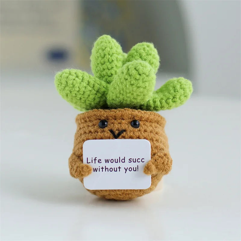 Handmade crochet positive energy doll featuring a green cactus top and brown body with a message card.