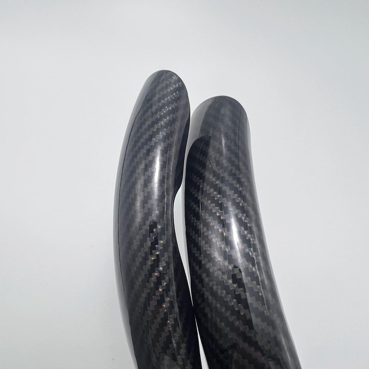 A close-up view of a carbon fiber pattern steering wheel cover with an anti-slip grip.