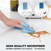 A hand is using a blue microfiber towel to absorb liquid on a white surface, demonstrating high absorbency and quality fiber 