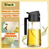 A black plastic dual-purpose oil spray bottle with a pump dispenser is shown pouring yellow oil.