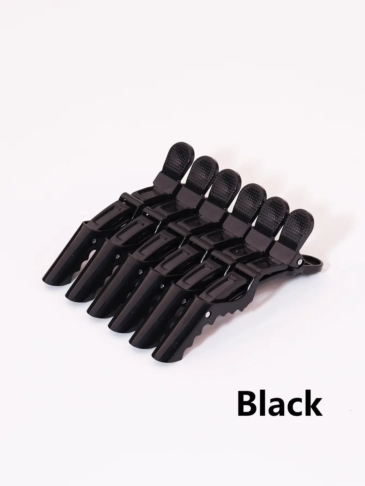 A set of black alligator hair clips for styling and sectioning.
