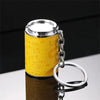 A yellow textured metal coin tube keychain with a silver cap and keyring.