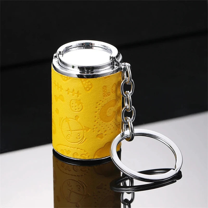 A yellow textured metal coin tube keychain with a silver cap and keyring.