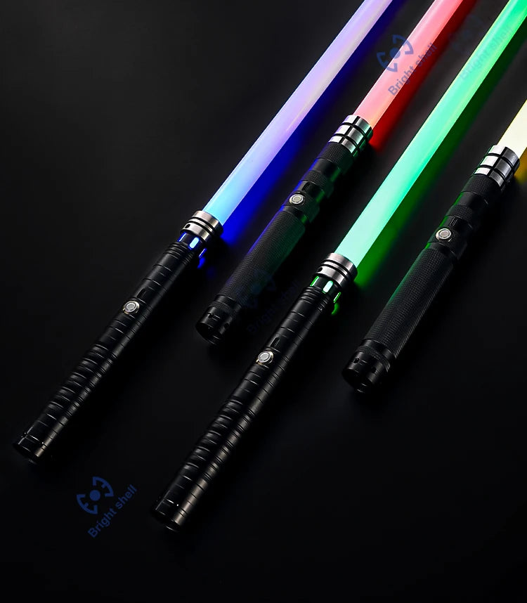 A close-up of an RGB lightsaber with a black hilt and a glowing pink and green blade against a dark background.