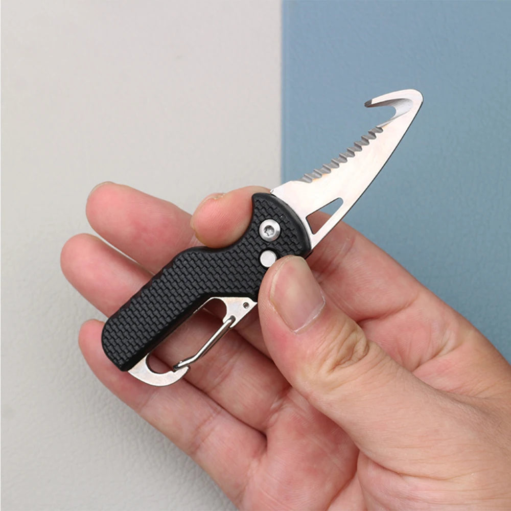 A hand holds a compact folding pocket knife with a serrated blade and gut hook against a light blue background.