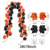 Artificial maple leaf garland in orange and black for autumn decor