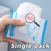 A hand holds a single pack of waterproof disposable toilet seat cover mats with a magnifying glass on the packaging.