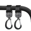 Black rotating hooks designed for hanging bags and essentials on a stroller bar.