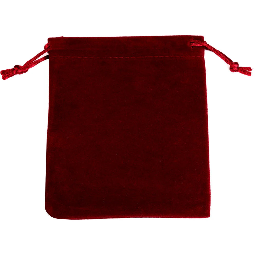 A deep red velvet drawstring jewelry pouch with tasseled ties.