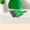 A set of green cartoon-themed cleaning tools including a broom and a dustpan resting on a white surface.