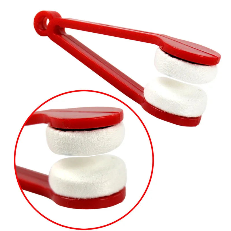 A red portable double-sided glasses cleaning brush with white microfiber pads shown in a close-up view.