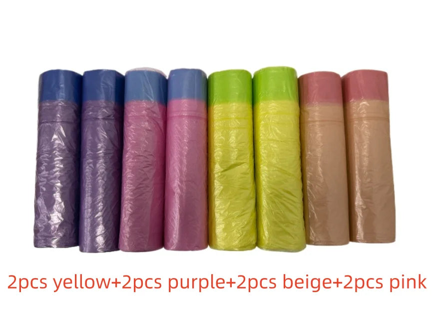 A row of scented drawstring trash bags in yellow, purple, beige, and pink colors.