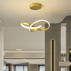 A modern pendant light with a gold finish and a curved white LED design hangs from the ceiling.