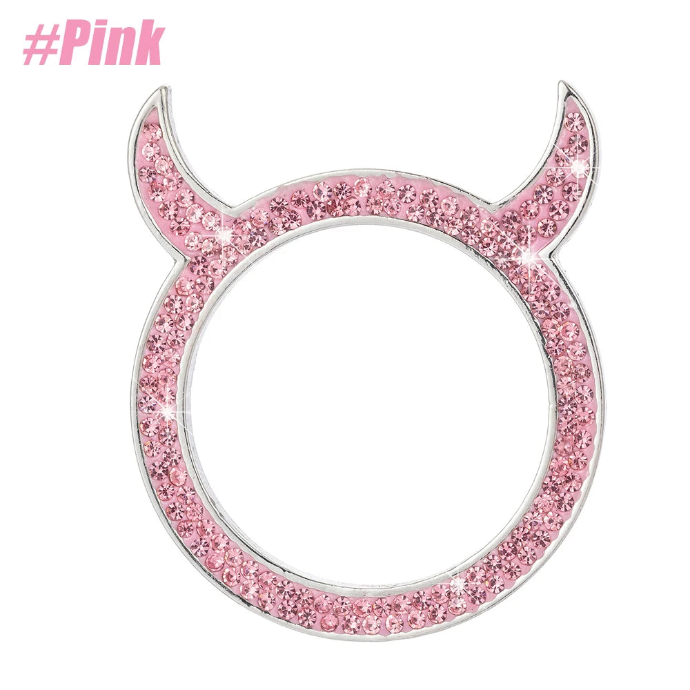 A pink crystal rhinestone car ignition button ring with a silver setting.