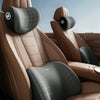 A memory foam car headrest and lumbar support pillow set in brown leather upholstery.