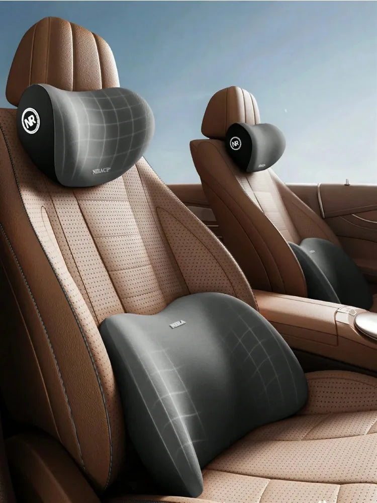 A memory foam car headrest and lumbar support pillow set in brown leather upholstery.