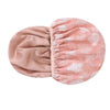 A large pink floral patterned satin-lined waterproof shower cap for hair protection.