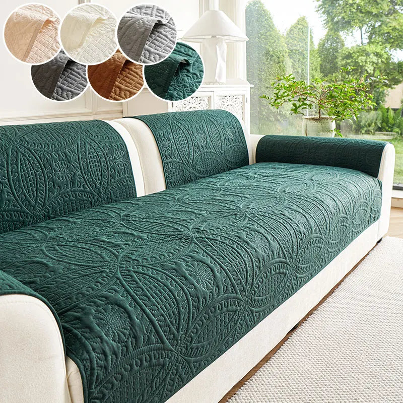 A dark green plush sofa cover with an embossed pattern displayed on a white sofa.