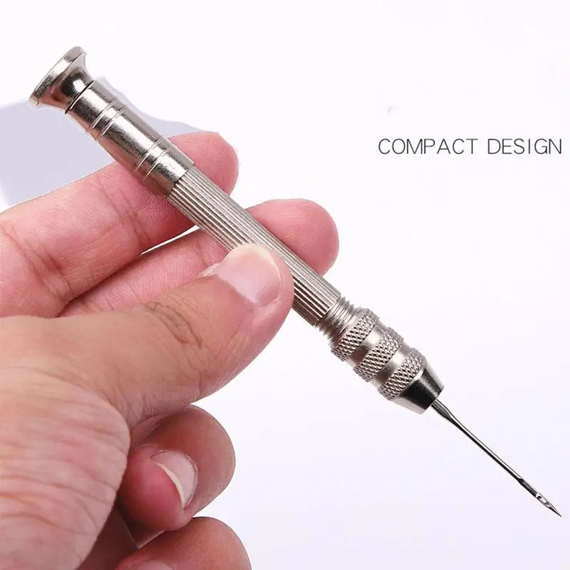 A hand holds a compact metal leather sewing awl set with replaceable needles.