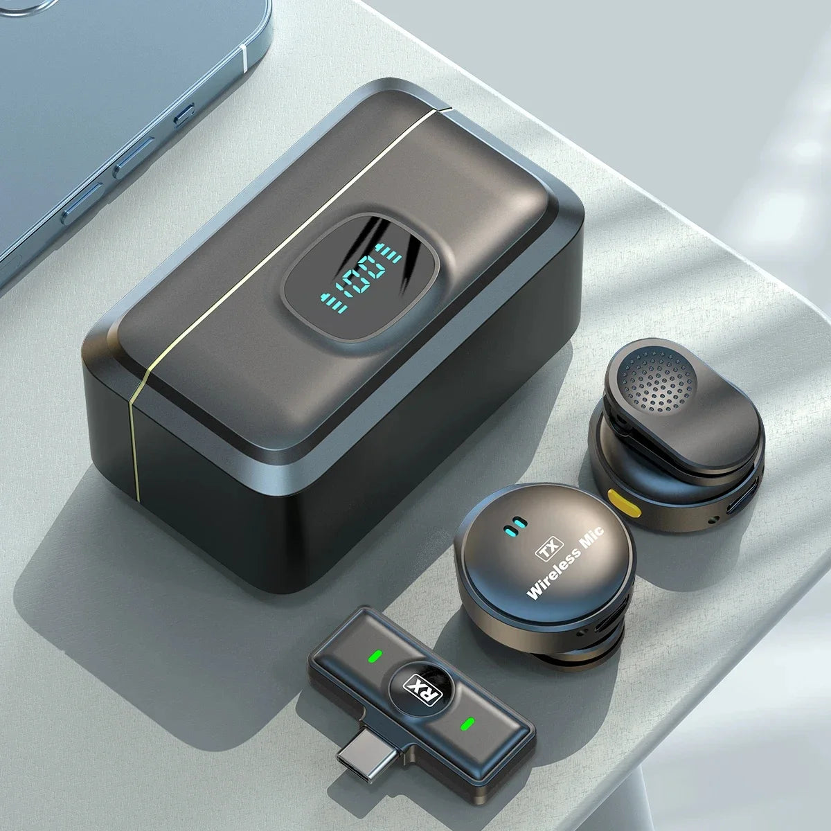A wireless lavalier microphone system shown with a charging case, magnetic clip, and receiver on a light gray surface.