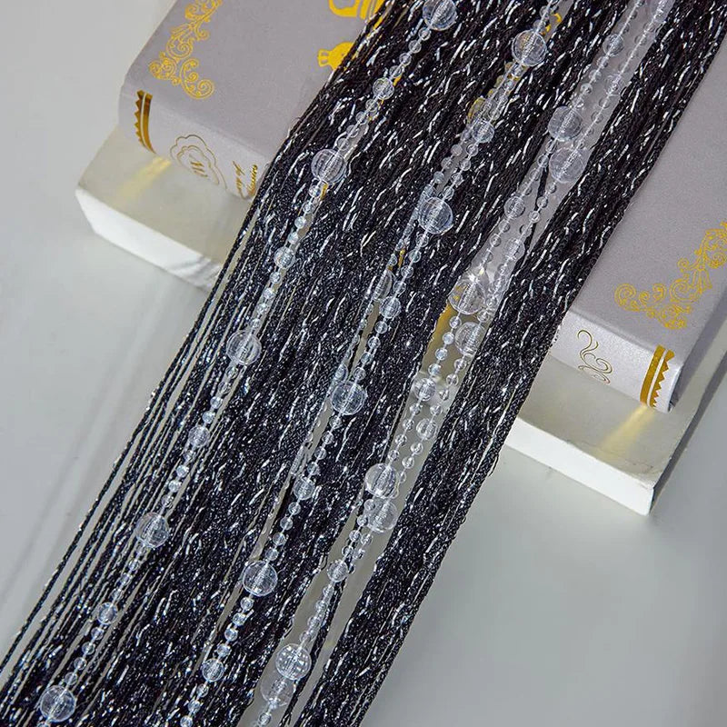 Black crystal beaded string curtain for doorways and windows displayed next to a box
